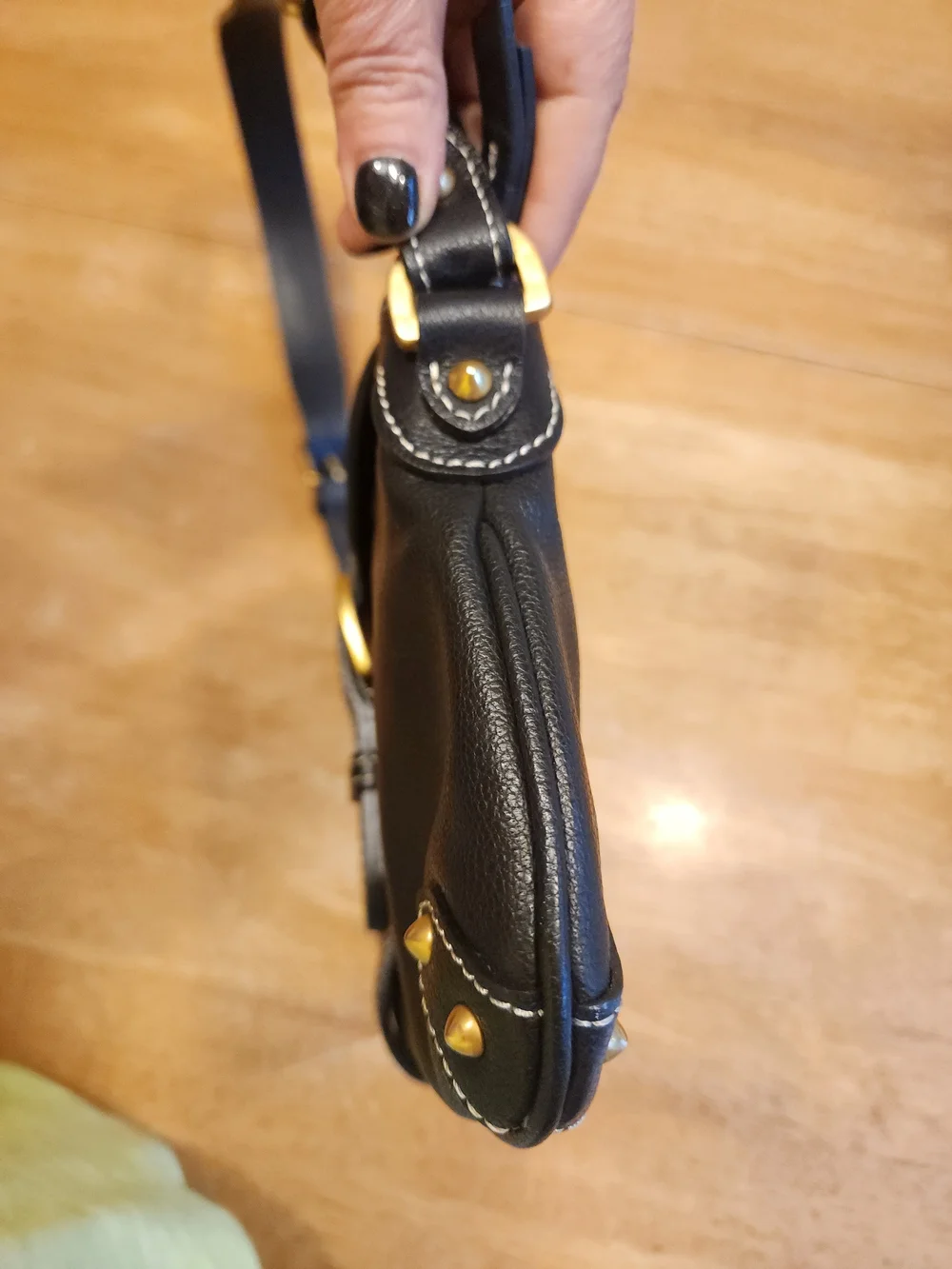 vintage Dooney & Bourke black leather shoulder bag featuring gold-tone hardware